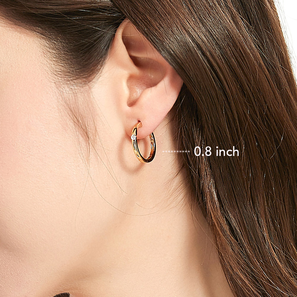 Model wearing Solitaire Round CZ Hoop Earrings in Gold Flashed Sterling Silver 0.12ct, 2 of 11