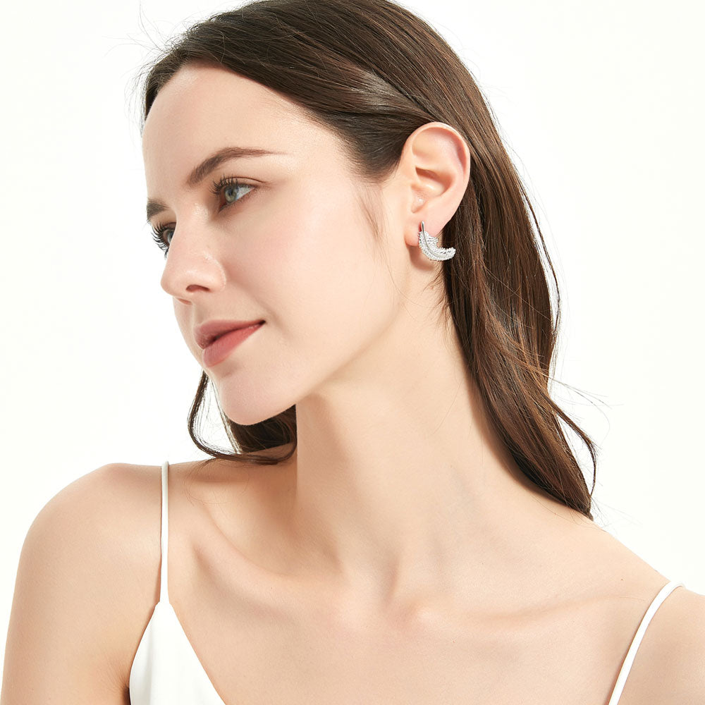 Model wearing Feather CZ Stud Earrings in Sterling Silver
