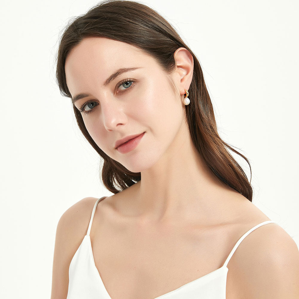 Model wearing Solitaire Irregular Cultured Pearl Stud Earrings in Sterling Silver