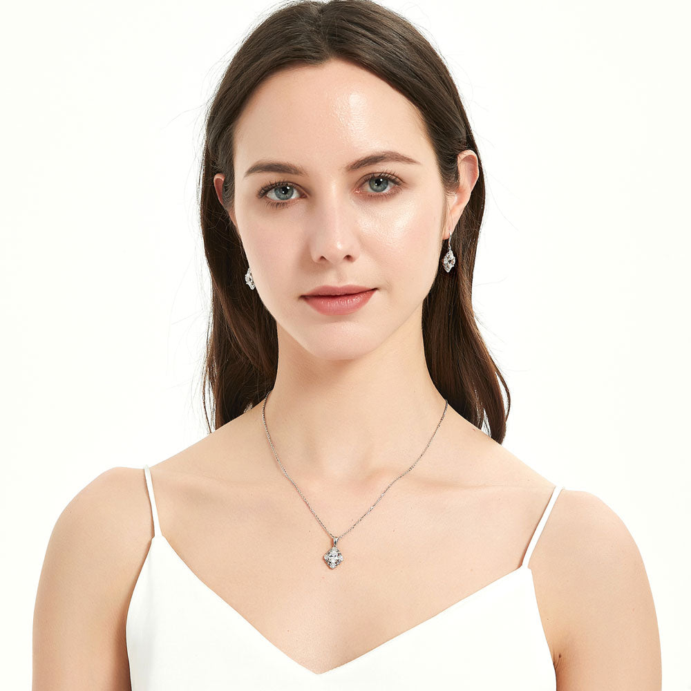 Model wearing Halo Flower Oval CZ Fish Hook Dangle Earrings in Sterling Silver