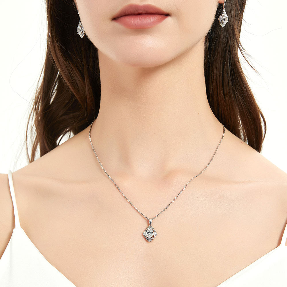 Model wearing Halo Flower Oval CZ Pendant Necklace in Sterling Silver, 2 of 7