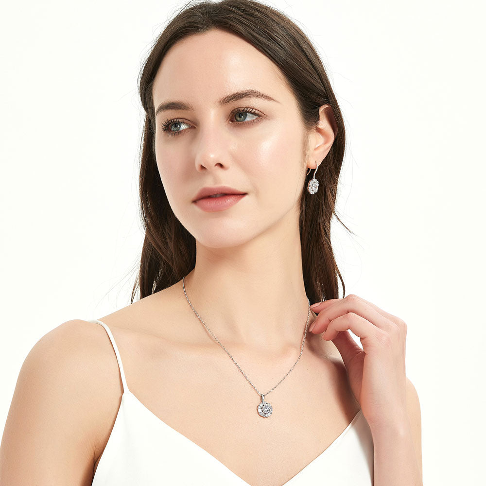 Model wearing Halo Cable Round CZ Fish Hook Dangle Earrings in Sterling Silver