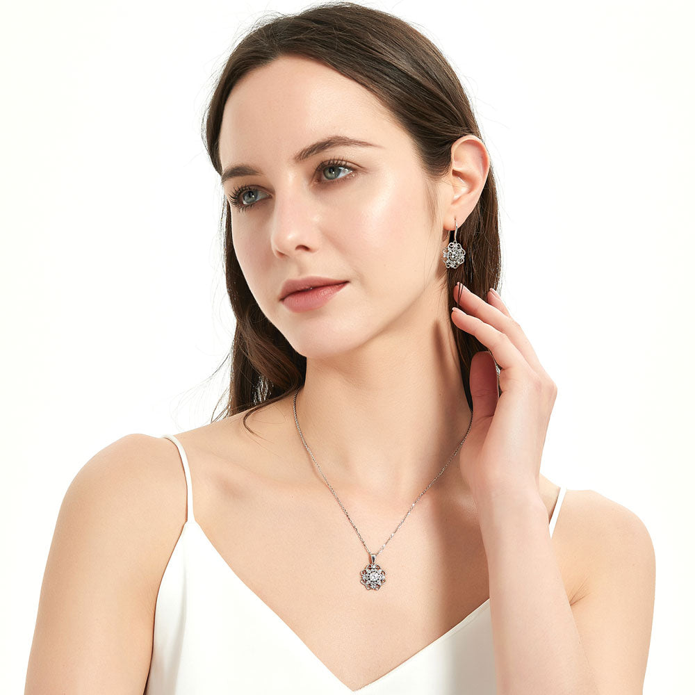 Model wearing Halo Flower Round CZ Fish Hook Dangle Earrings in Sterling Silver