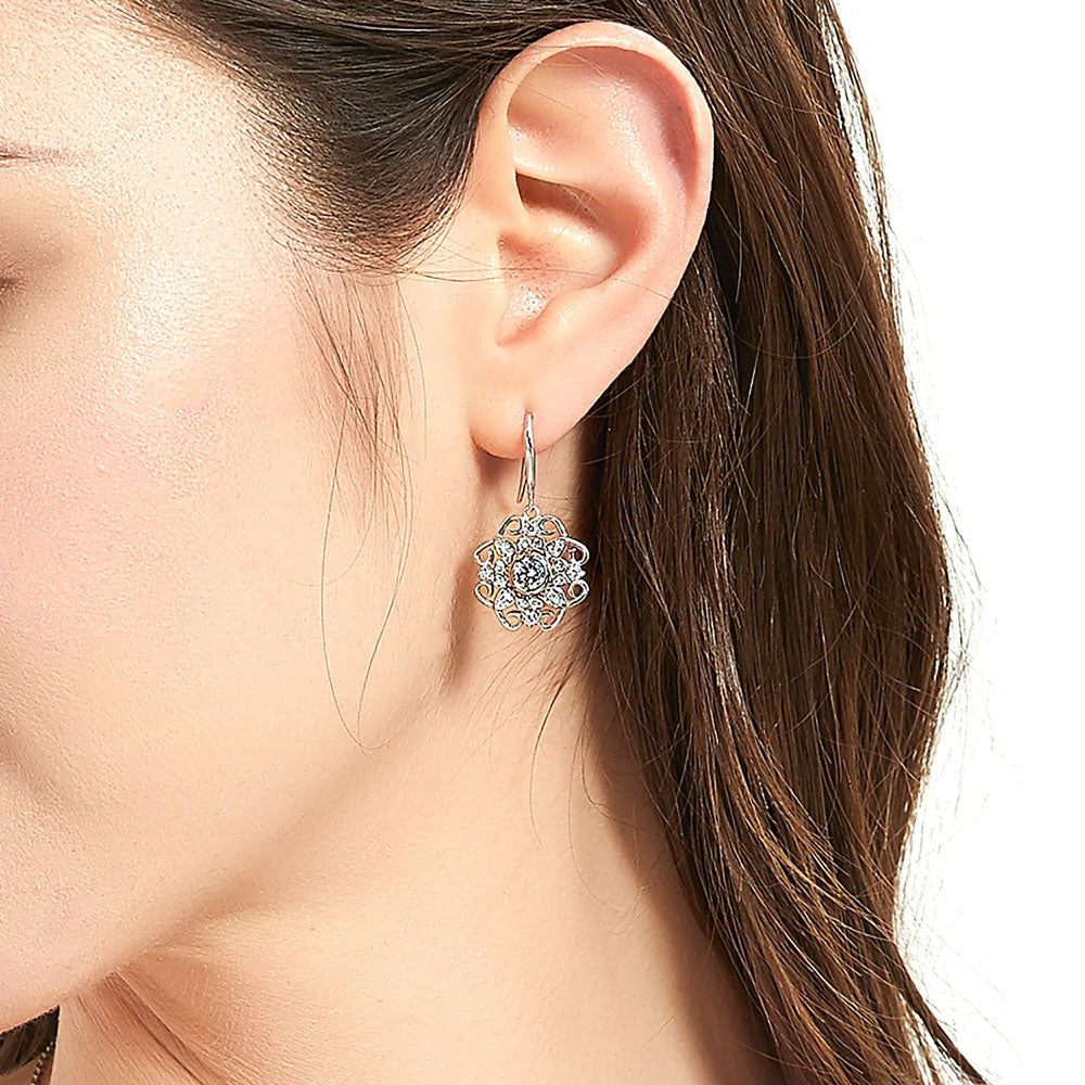 Model wearing Halo Flower Round CZ Fish Hook Dangle Earrings in Sterling Silver