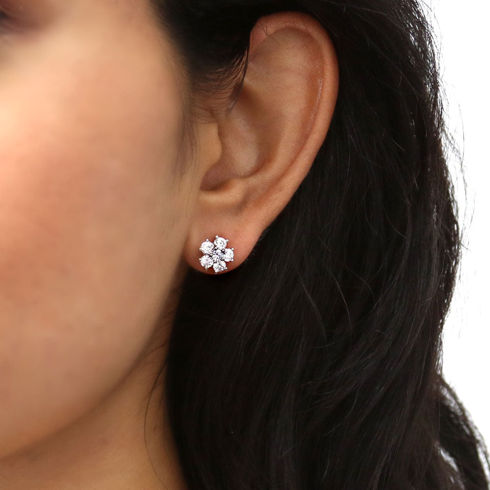 Model wearing Flower CZ Stud Earrings in Sterling Silver