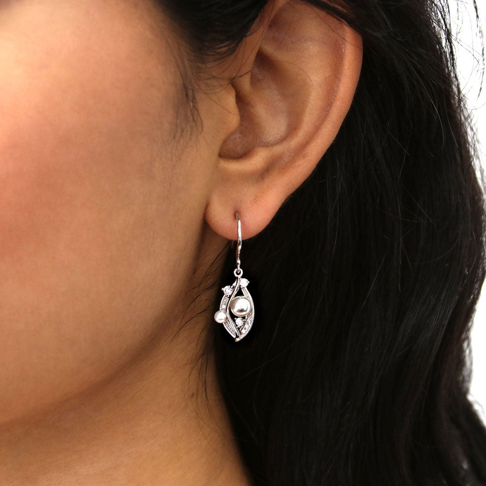 Model wearing Imitation Pearl Fish Hook Dangle Earrings in Sterling Silver