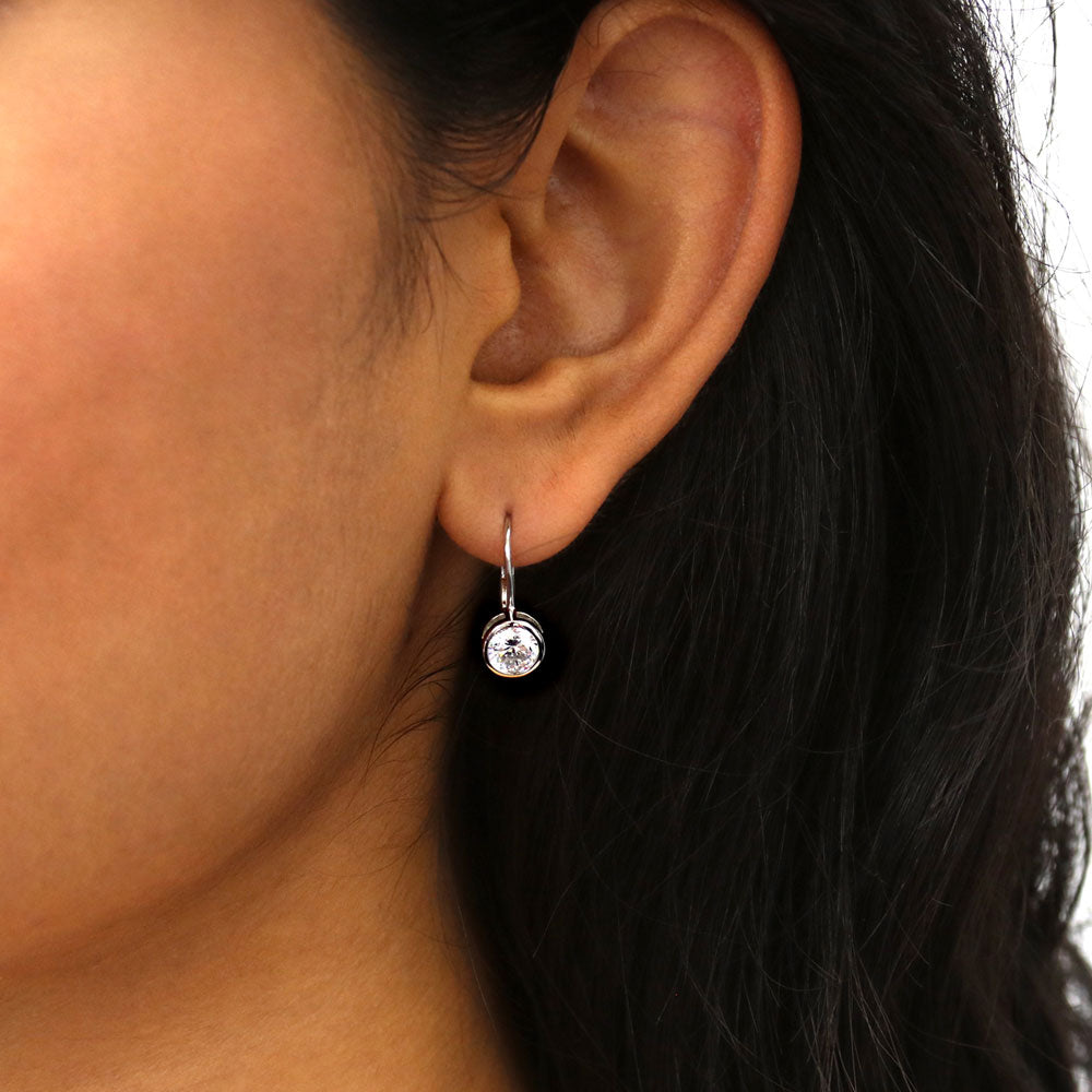 Model wearing Solitaire 1.2ct Bezel Set Round CZ Dangle Earrings in Sterling Silver