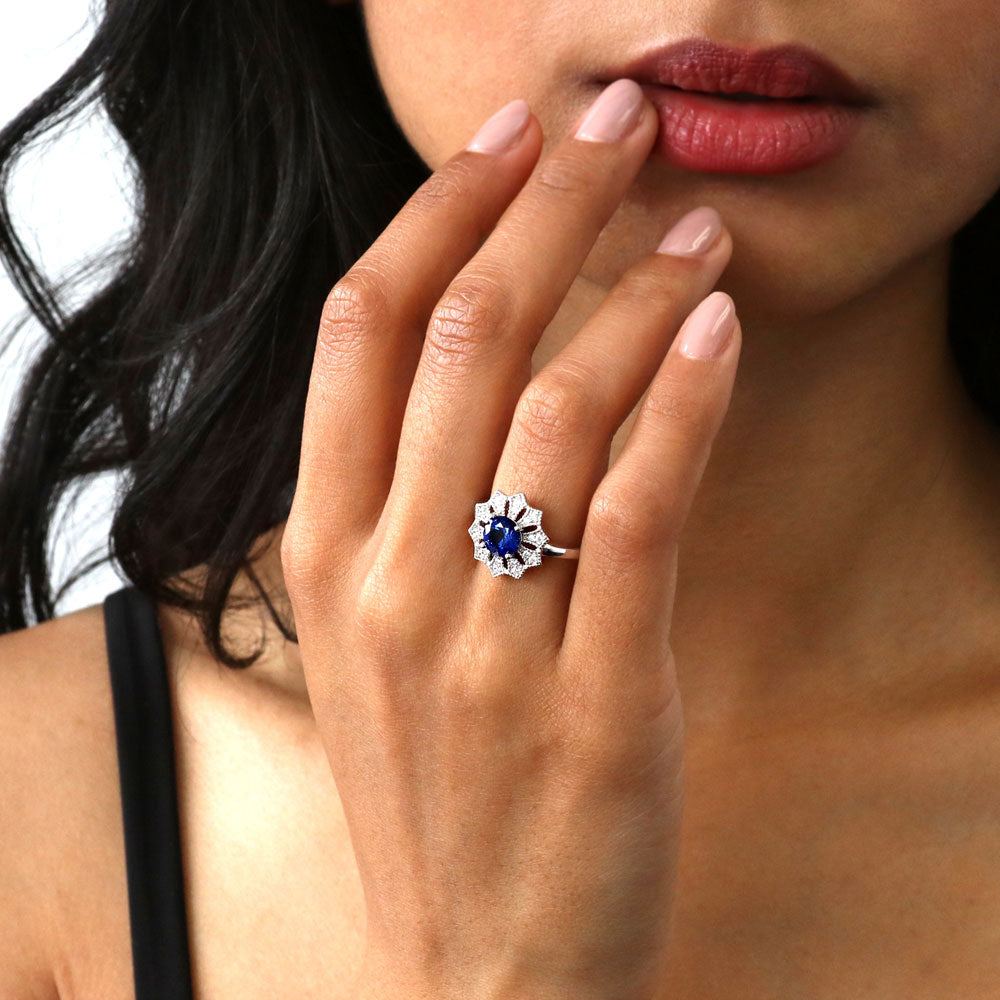 Model wearing Flower Halo Blue CZ Ring in Sterling Silver