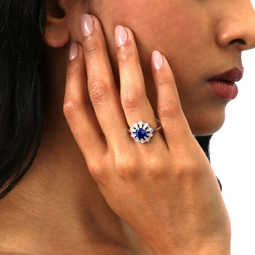 Model wearing Flower Halo Blue CZ Ring in Sterling Silver