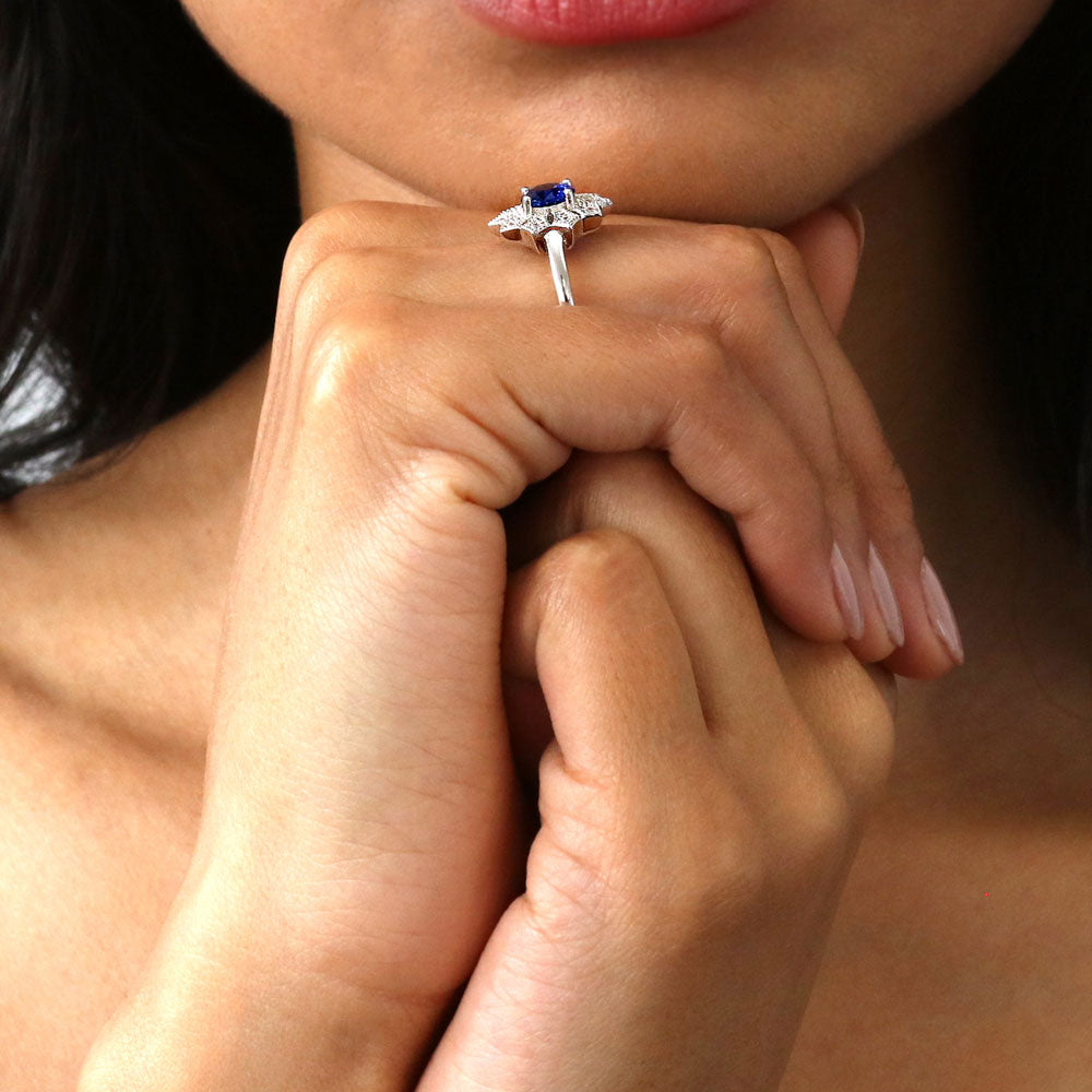 Model wearing Flower Halo Blue CZ Ring in Sterling Silver