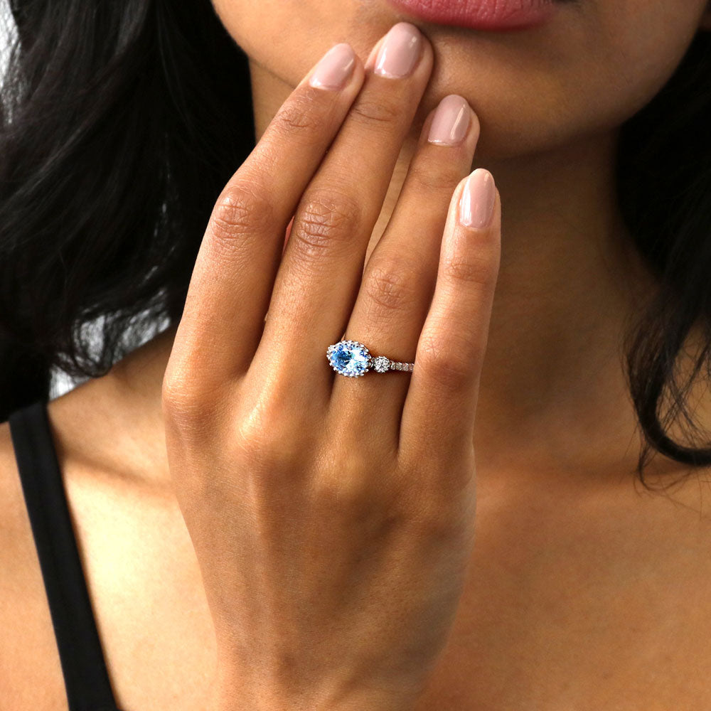 Model wearing 3-Stone Greyish Blue Oval CZ Ring in Sterling Silver, 3 of 9