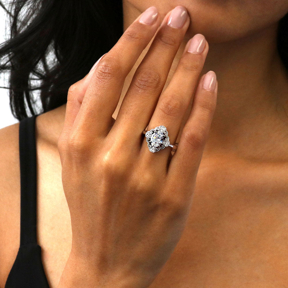 Model wearing Halo Flower Oval CZ Ring in Sterling Silver