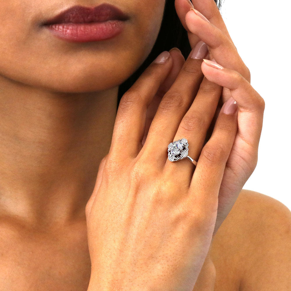 Model wearing Halo Flower Oval CZ Ring in Sterling Silver