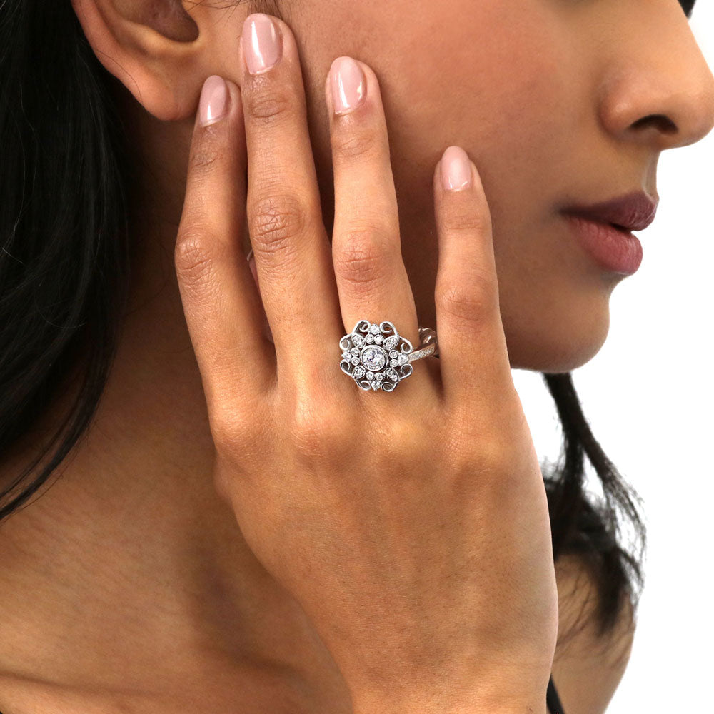 Model wearing Halo Flower Round CZ Ring in Sterling Silver, 2 of 9