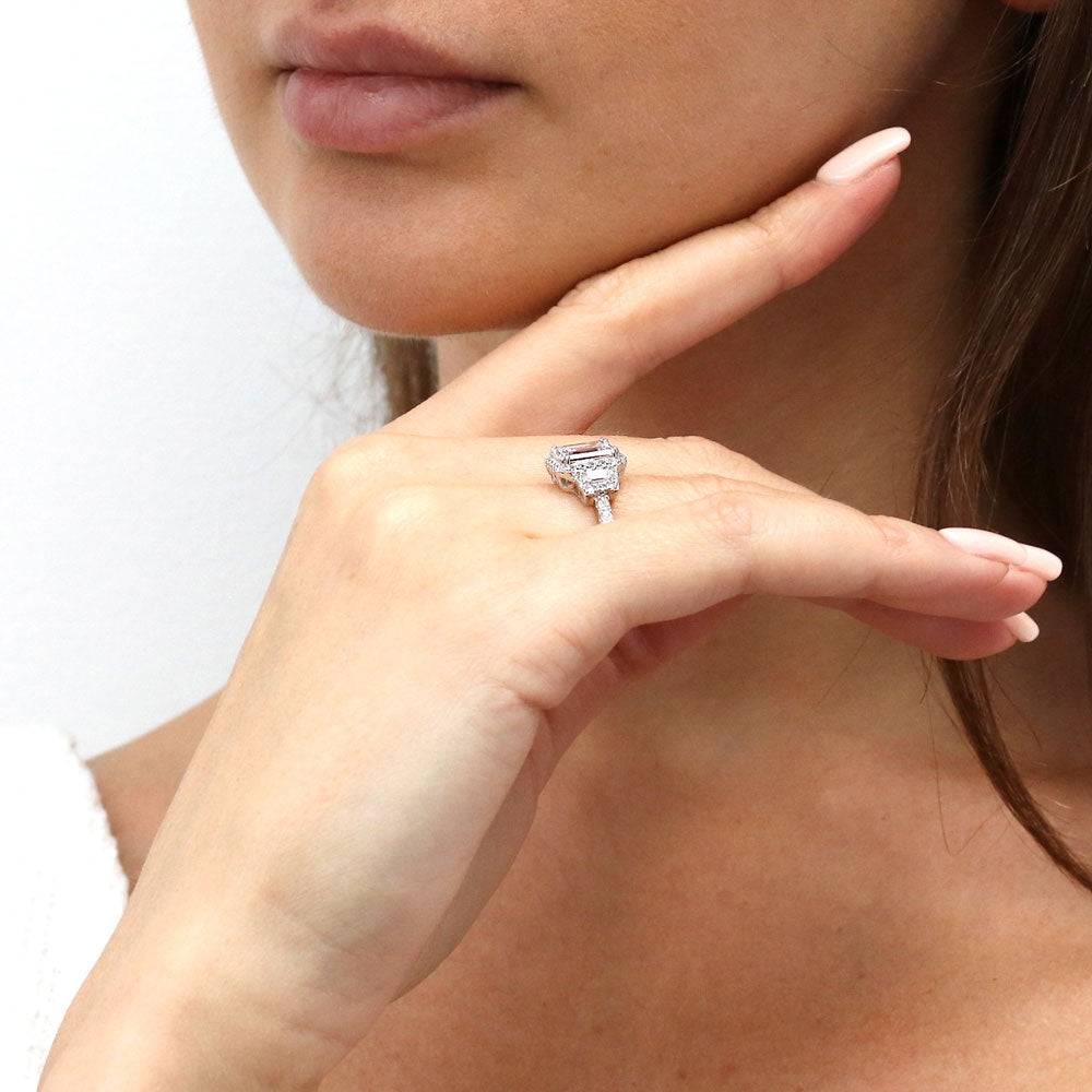 Model wearing 3-Stone Halo Step Emerald Cut CZ Ring in Sterling Silver