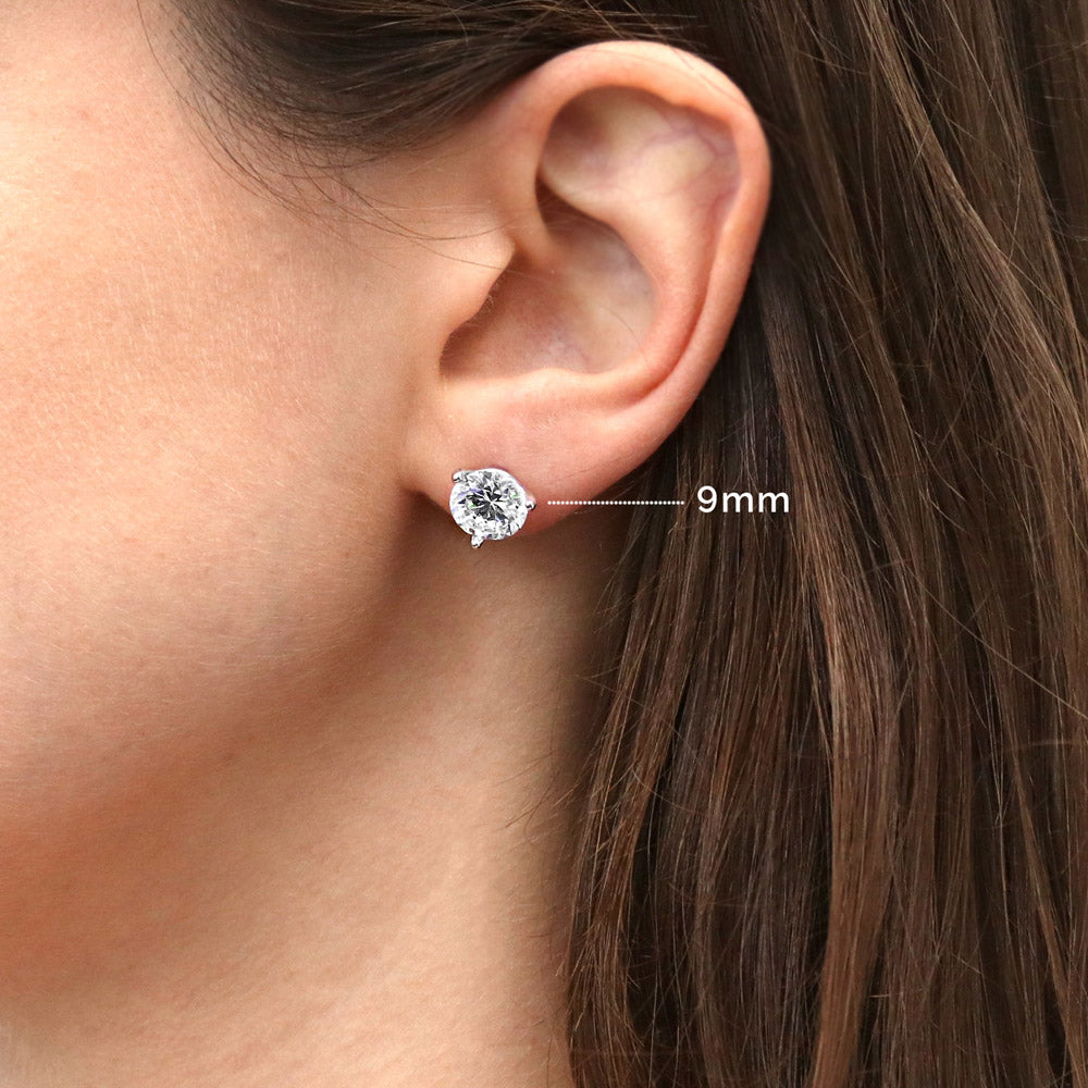 Model wearing Solitaire Round CZ Stud Earrings in Sterling Silver