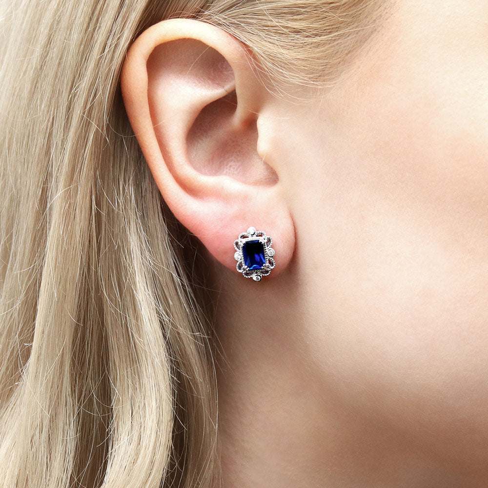 Model wearing Art Deco Simulated Blue Sapphire CZ Stud Earrings in Sterling Silver