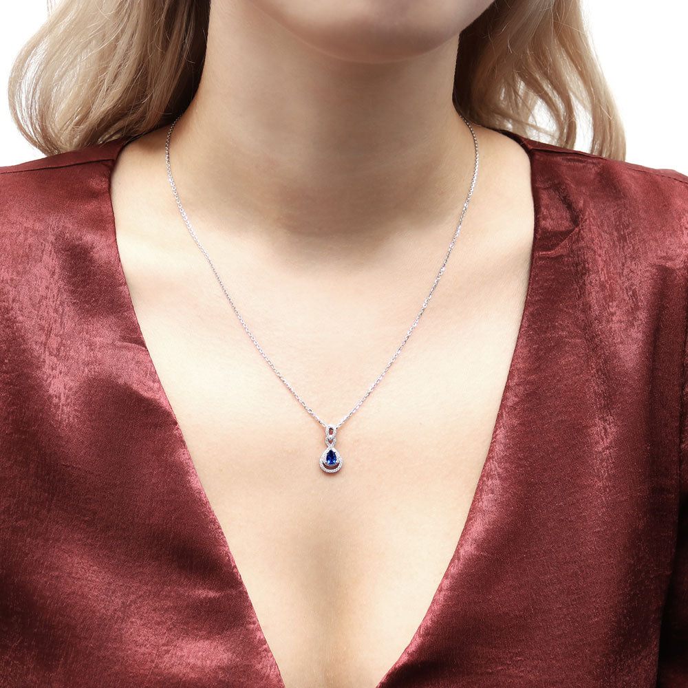 Model wearing Teardrop Simulated Blue Sapphire CZ Pendant Necklace in Sterling Silver, 2 of 8