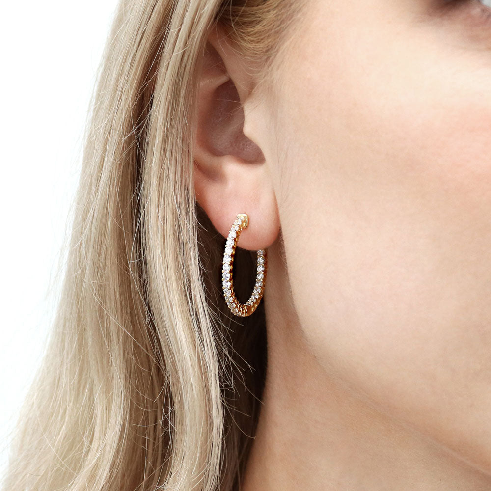 Model wearing CZ Small Inside-Out Hoop Earrings in Sterling Silver 1 inch, Yellow Gold Flashed