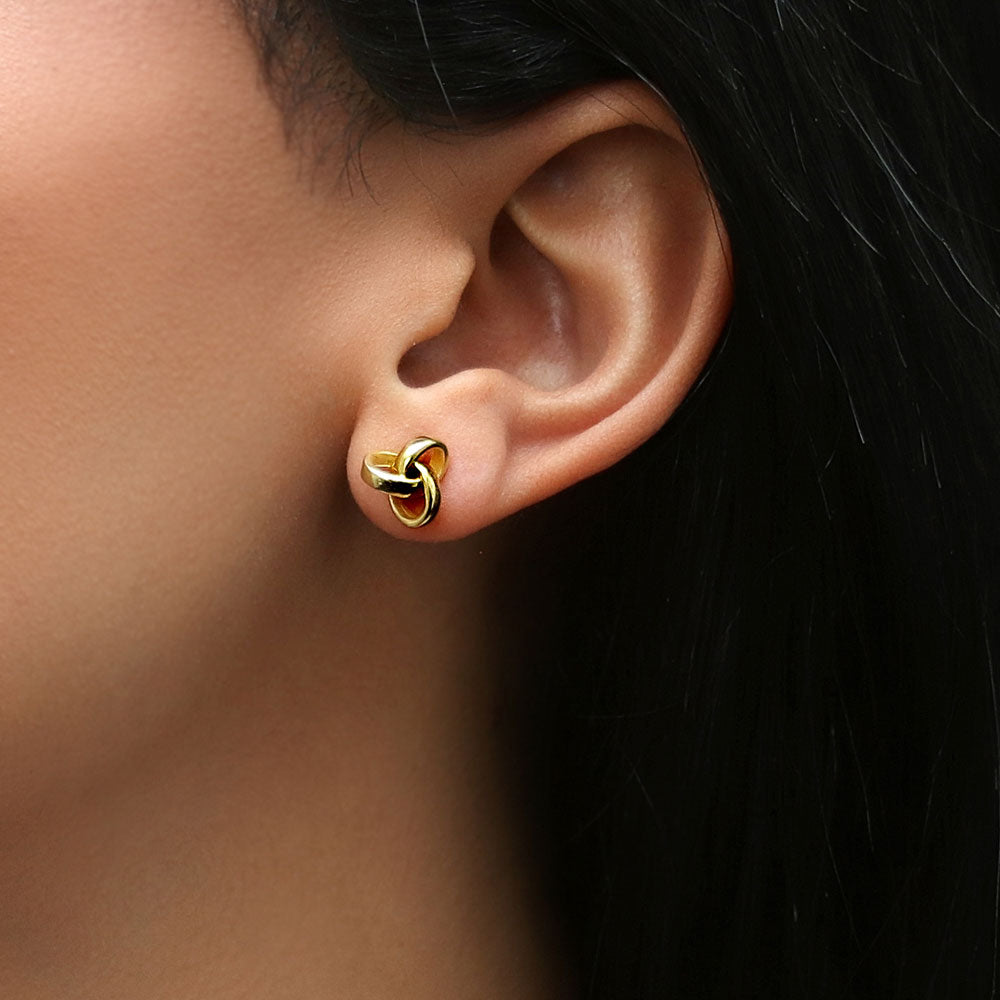 Model wearing Love Knot Stud Earrings in Sterling Silver