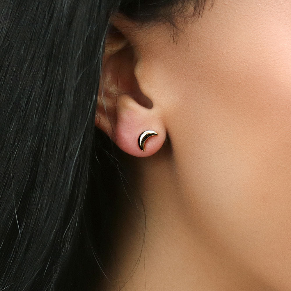 Model wearing Crescent Moon Cartilage Stud Earrings in Sterling Silver, Yellow Gold Flashed