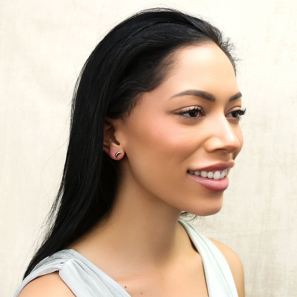 Model wearing Crescent Moon Stud Earrings in Sterling Silver