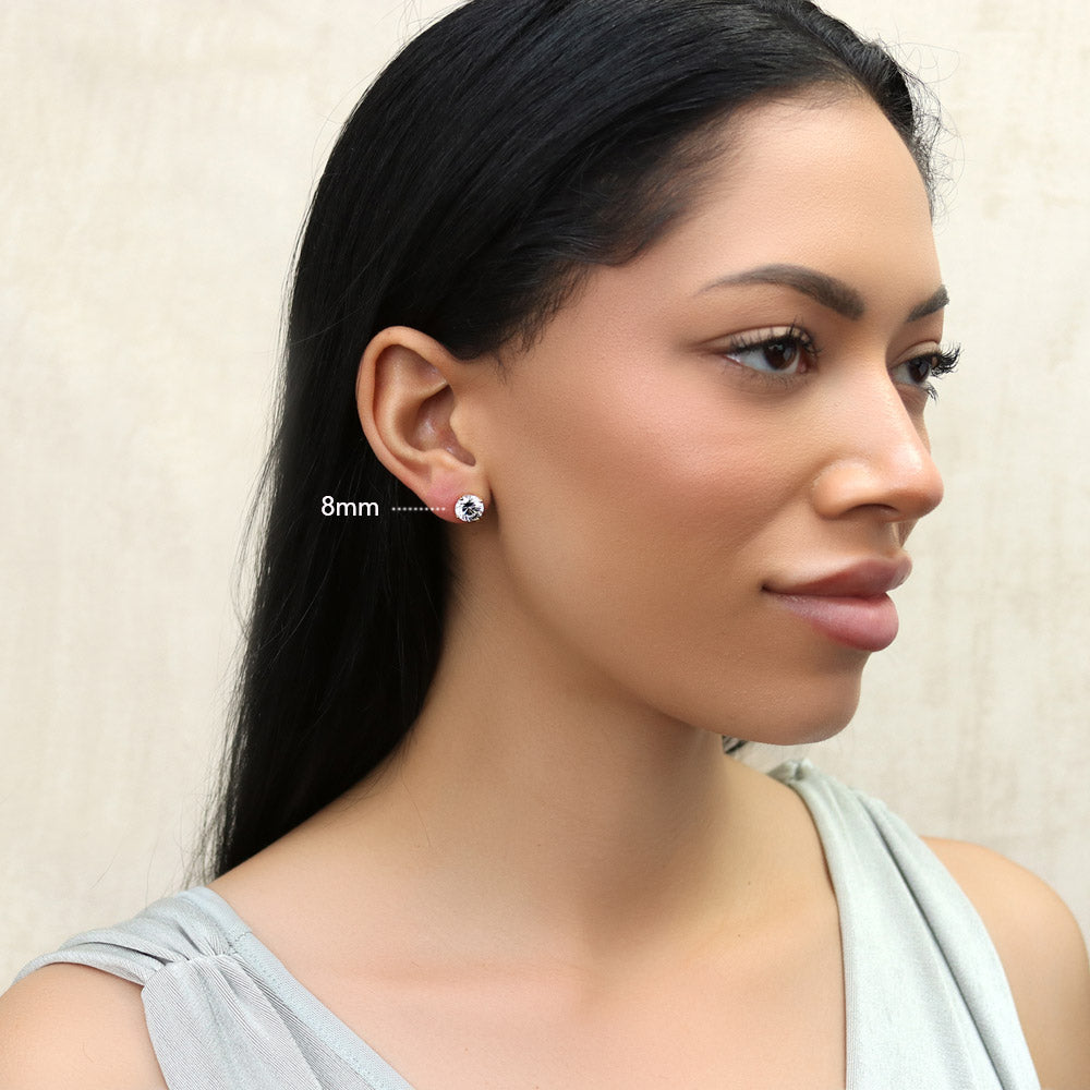 Model wearing Solitaire Round CZ Stud Earrings in Gold Flashed Sterling Silver