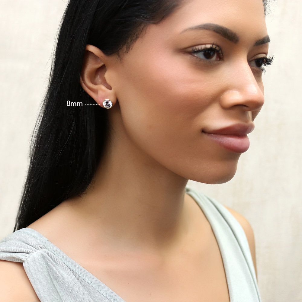 Model wearing Solitaire Bezel Set Round CZ Stud Earrings in Sterling Silver