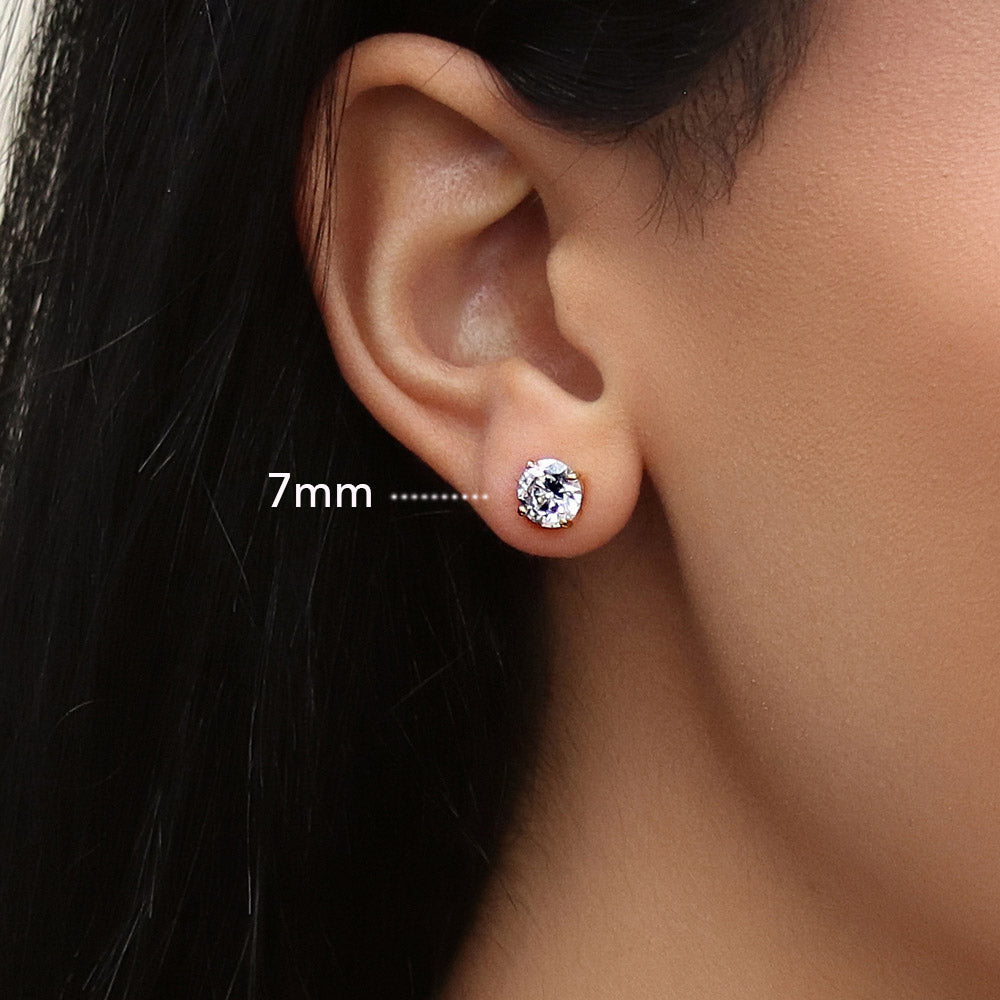 Model wearing Solitaire Round CZ Stud Earrings in Gold Flashed Sterling Silver