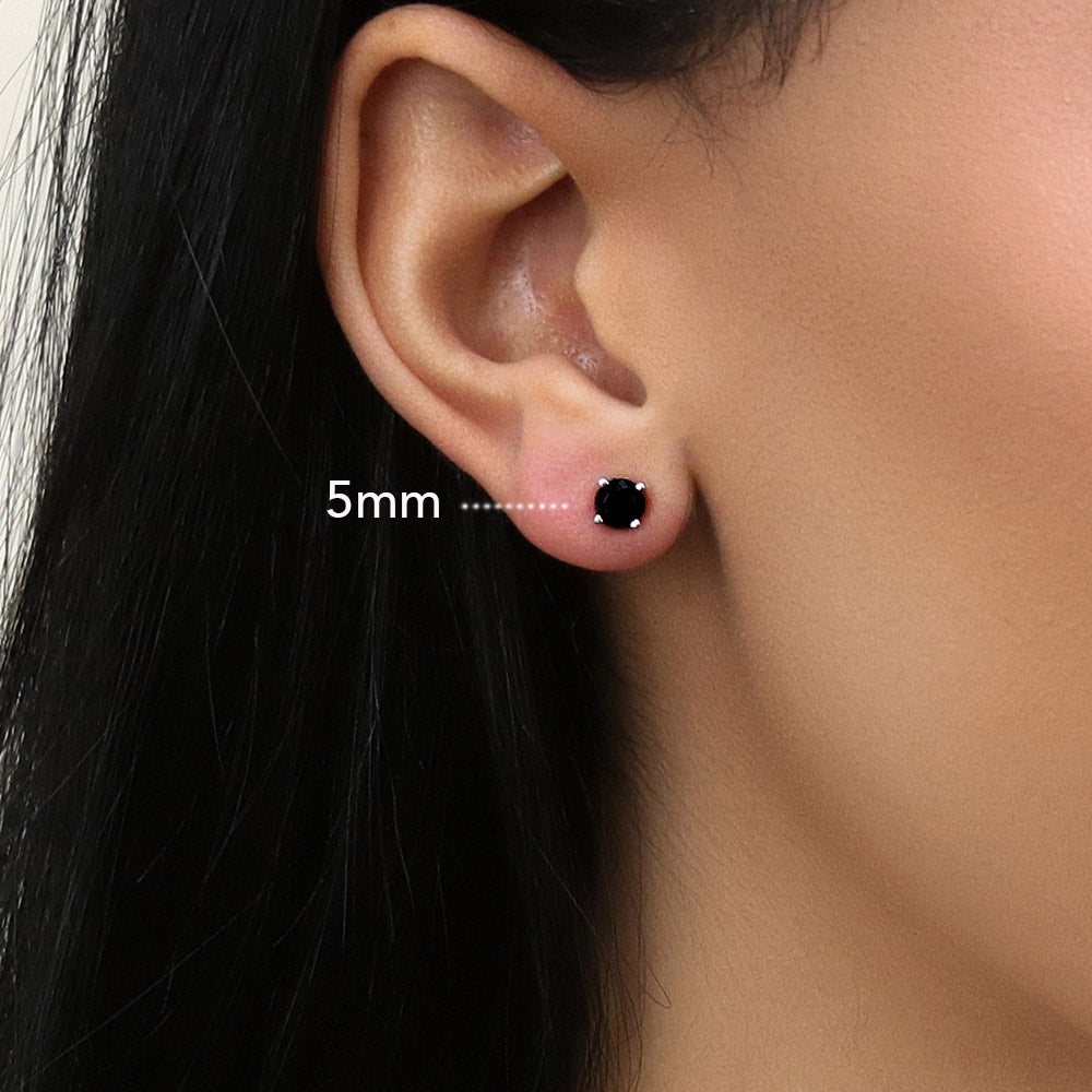 Model wearing Solitaire Black Round CZ Stud Earrings in Sterling Silver