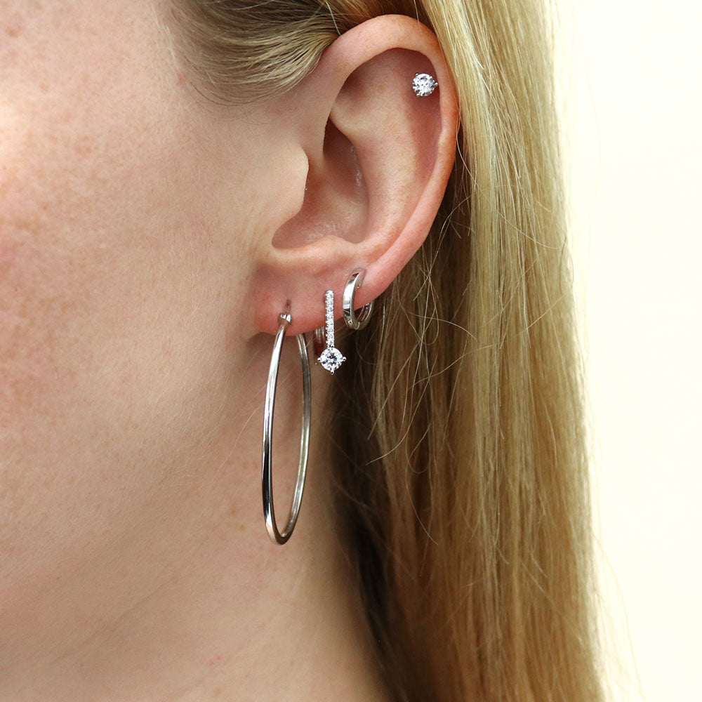 Model wearing Halo Solitaire Round CZ Stud Earrings in Sterling Silver, 2 Pairs, 17 of 19