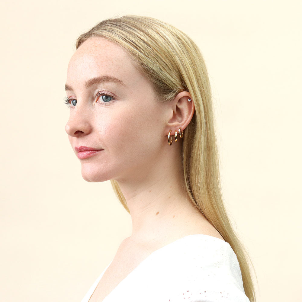 Model wearing Solitaire Round CZ Hoop Earrings in Gold Flashed Sterling Silver 0.12ct, 9 of 11