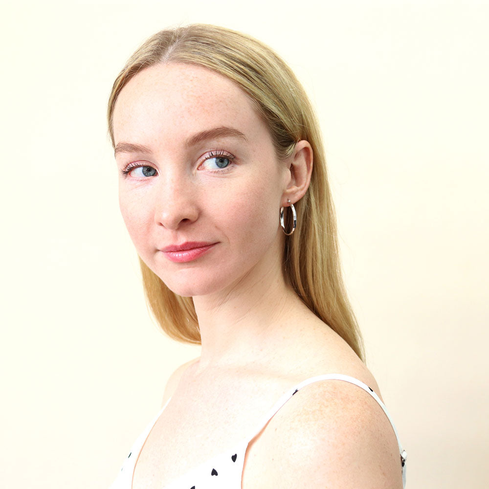 Model wearing Medium Hoop Earrings in Sterling Silver 1.2 inch