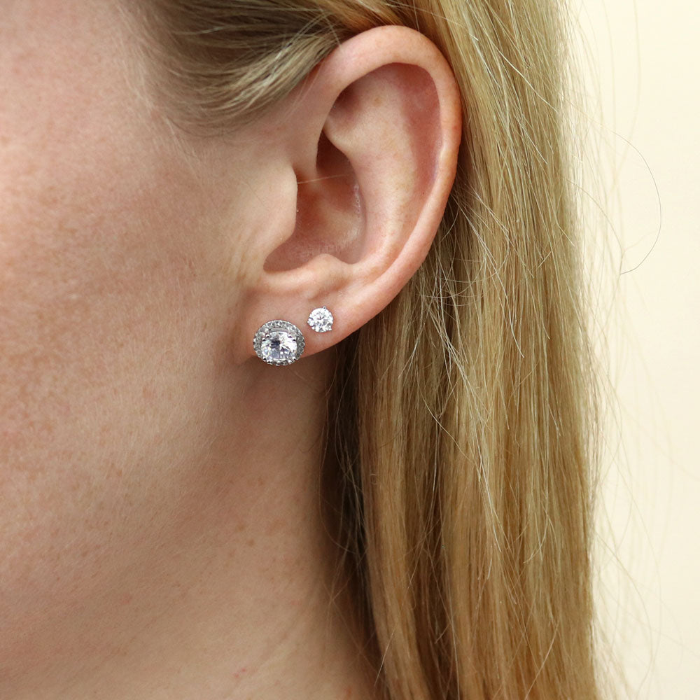 Model wearing Halo Solitaire Round CZ Stud Earrings in Sterling Silver, 2 Pairs