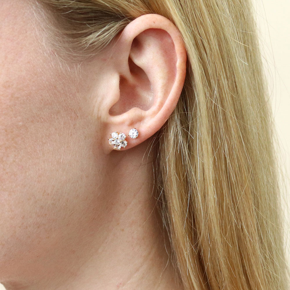 Model wearing Flower CZ Stud Earrings in Sterling Silver