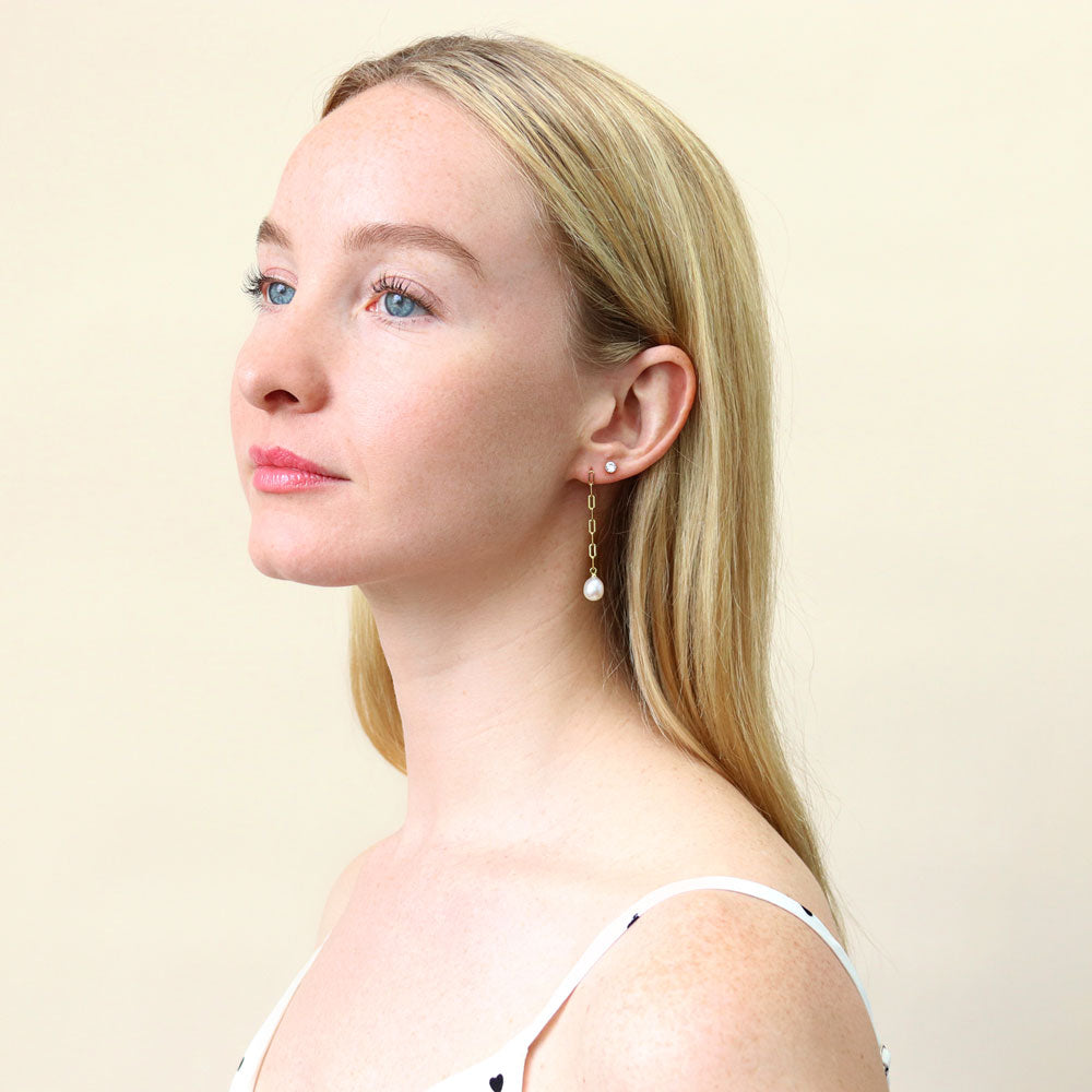 Model wearing Solitaire White Oval Cultured Pearl Earrings in Sterling Silver