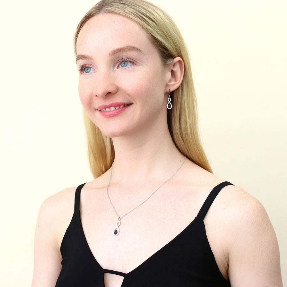 Model wearing Black and White Woven CZ Dangle Earrings in Sterling Silver