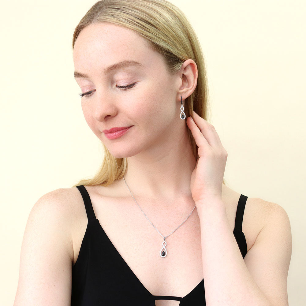 Model wearing Black and White Woven CZ Dangle Earrings in Sterling Silver