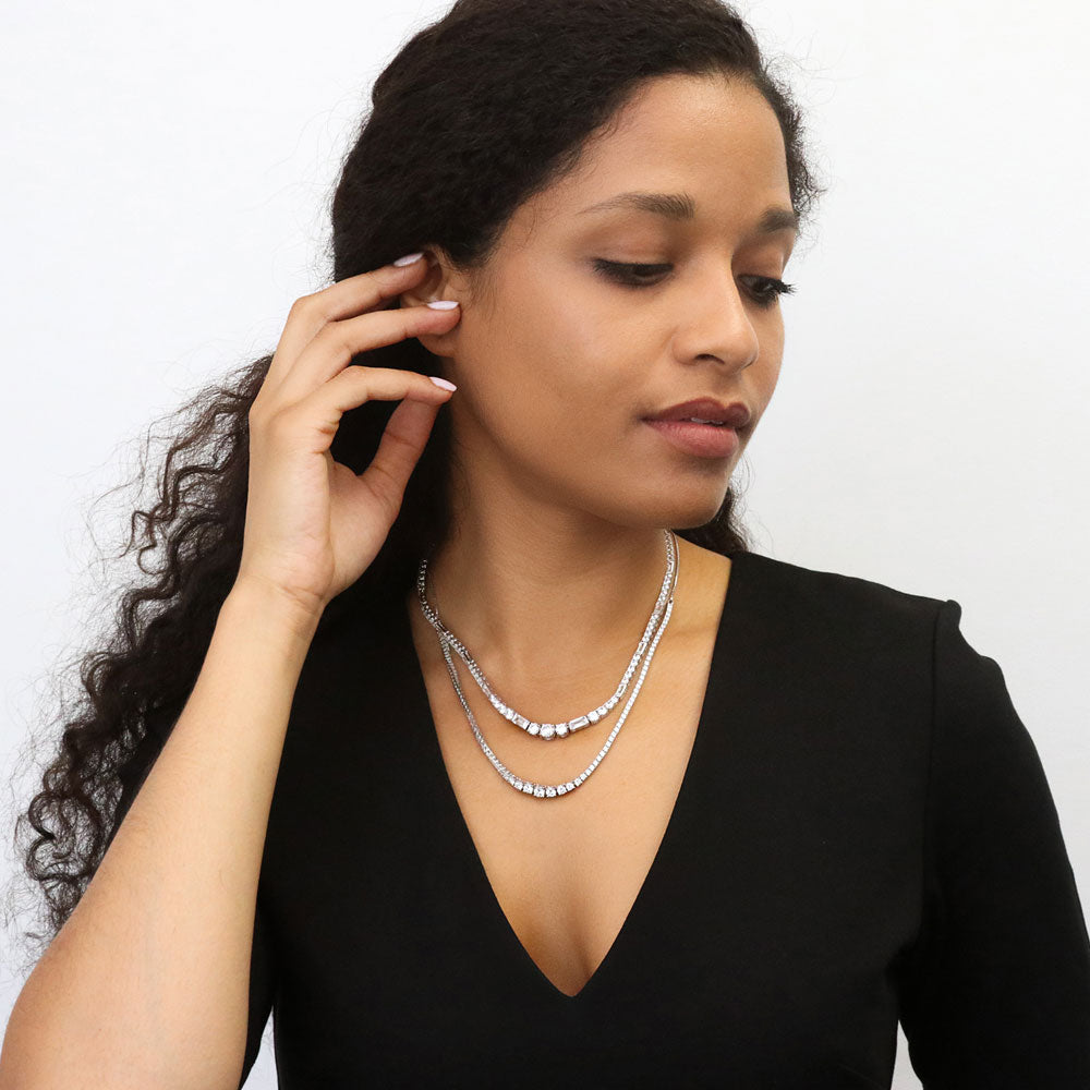 Model wearing Graduated Halo CZ Pendant And Tennis Necklace Set in Sterling Silver