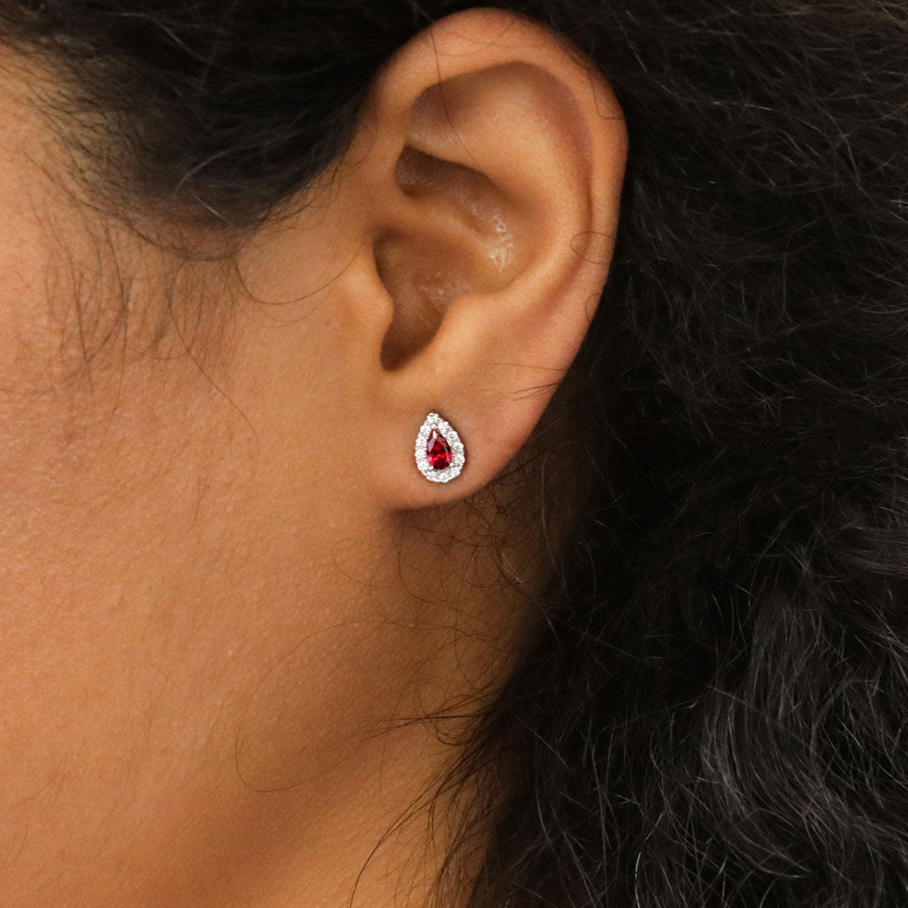 Model wearing Halo Pear CZ Stud Earrings in Sterling Silver