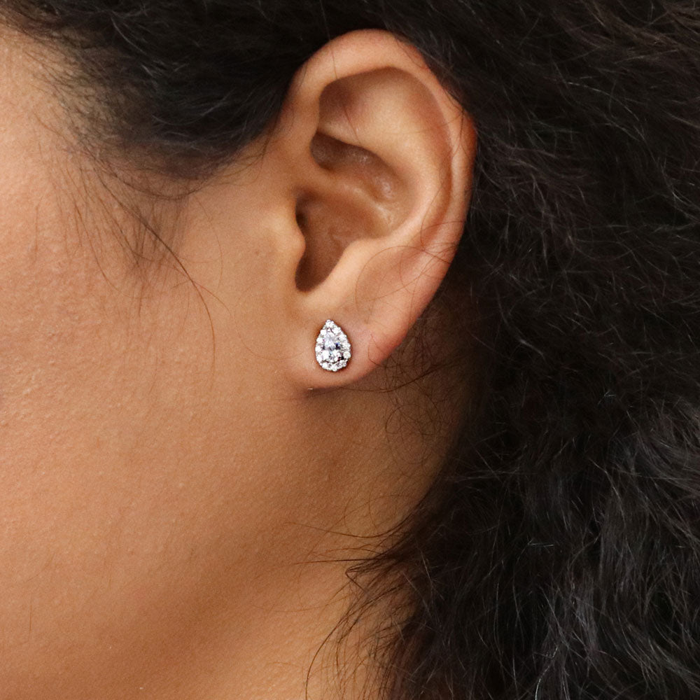 Model wearing Halo Pear CZ Stud Earrings in Sterling Silver