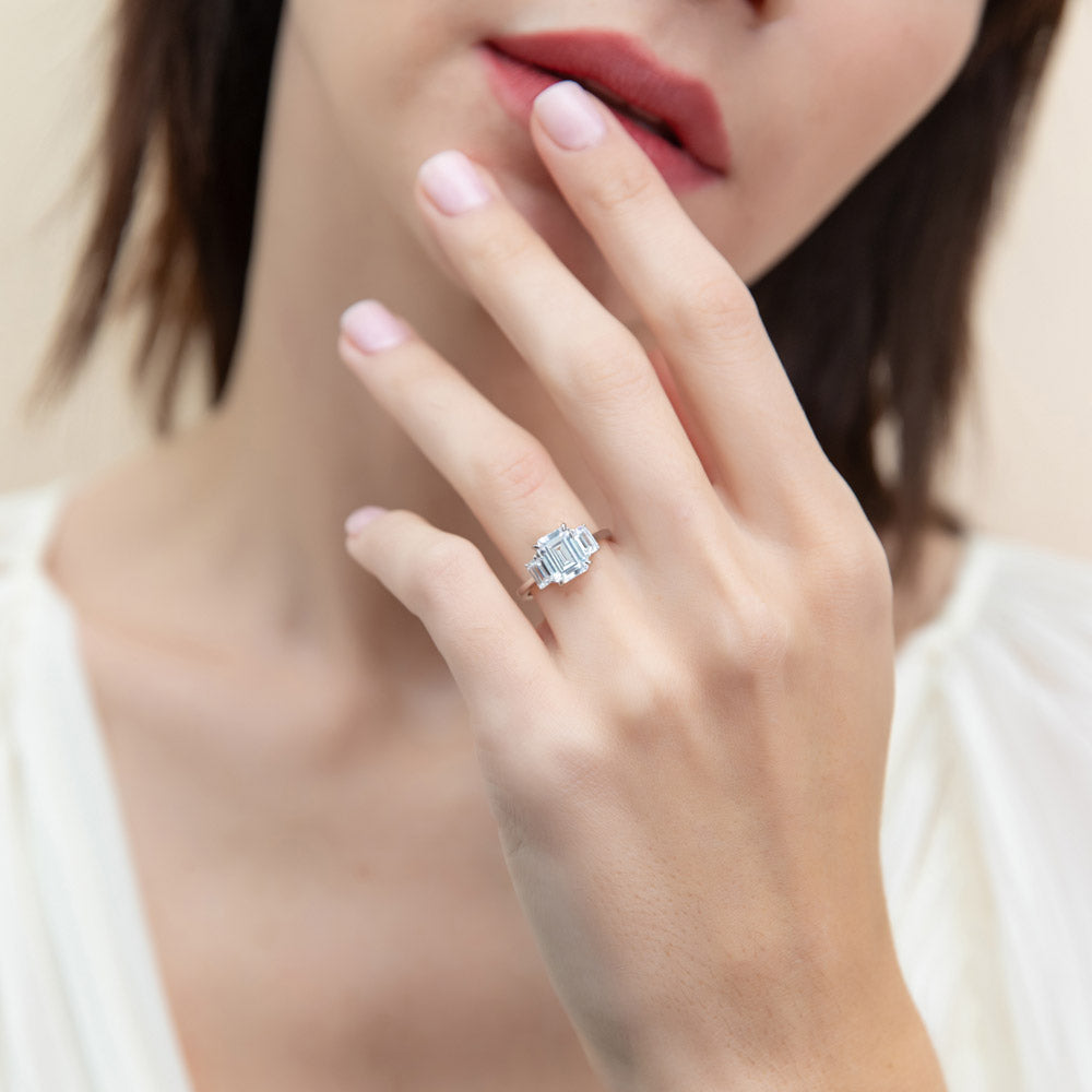Model wearing 3-Stone Step Emerald Cut CZ Ring in Sterling Silver, 3 of 9