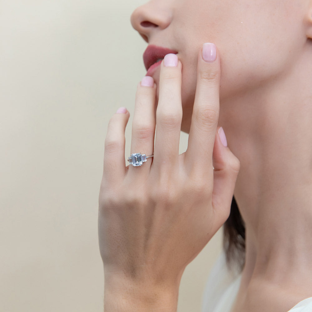 Model wearing 3-Stone Step Emerald Cut CZ Ring in Sterling Silver, 2 of 9