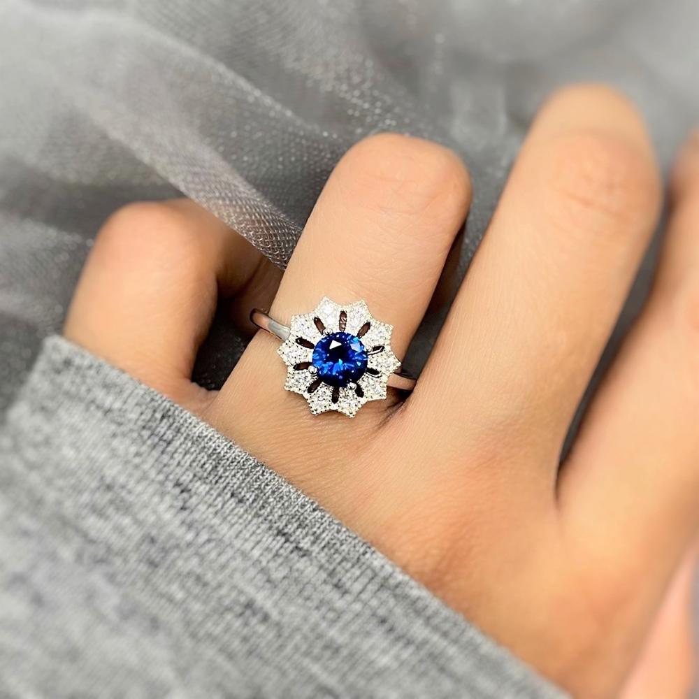 Model wearing Flower Halo Blue CZ Ring in Sterling Silver