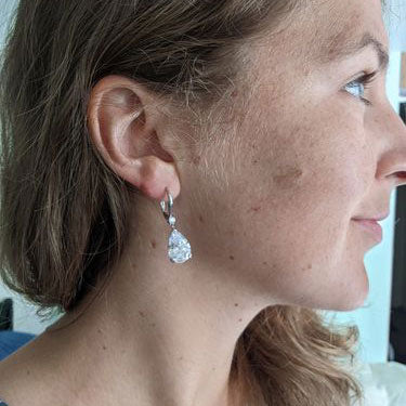 Model Wearing Solitaire with Side Stones Dangle Earrings