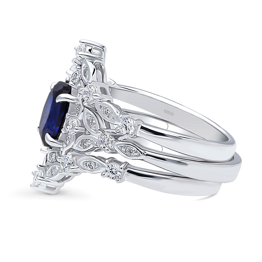 Angle view of Chevron Halo Simulated Blue Sapphire CZ Ring Set in Sterling Silver