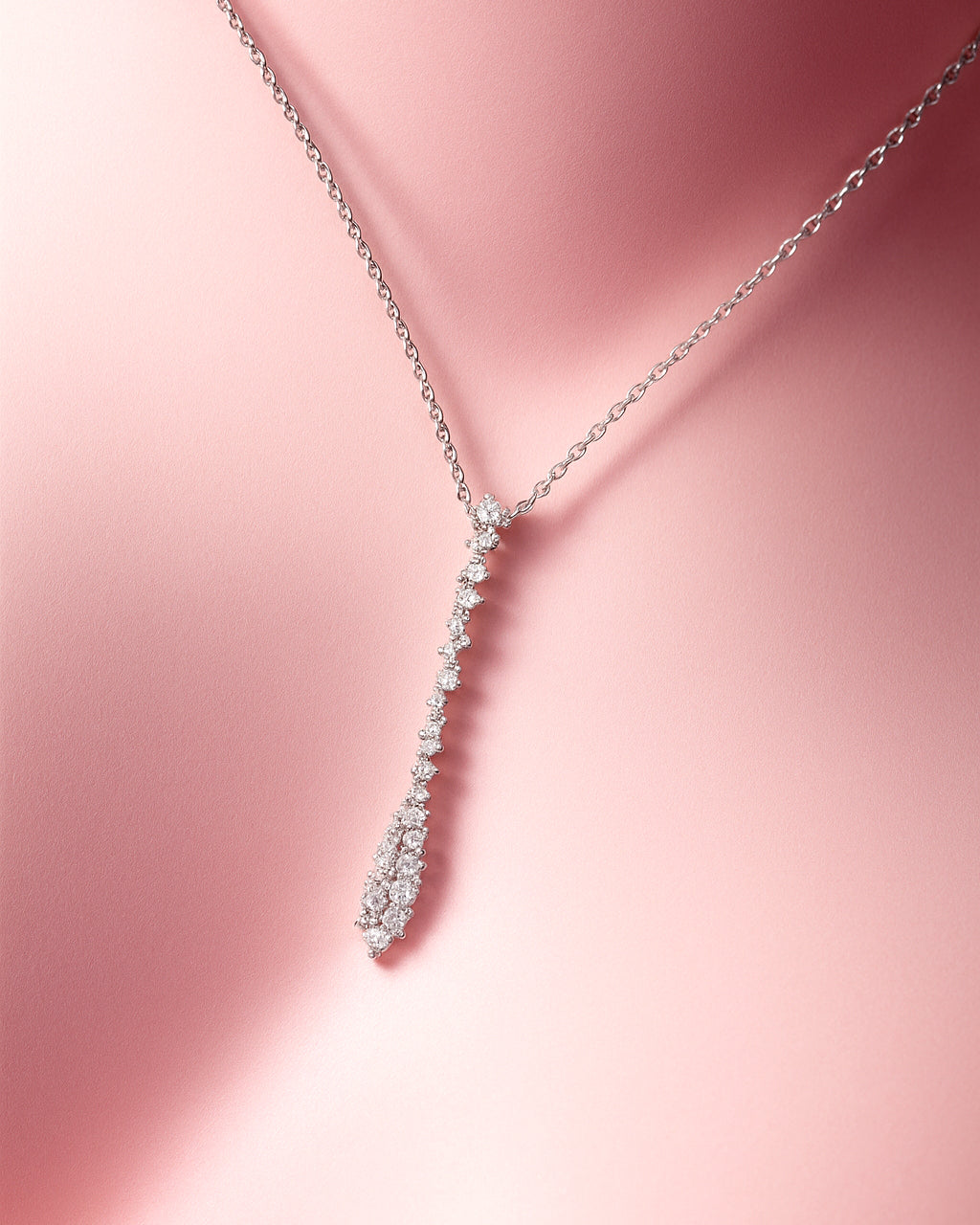 Silver necklace on a pink background