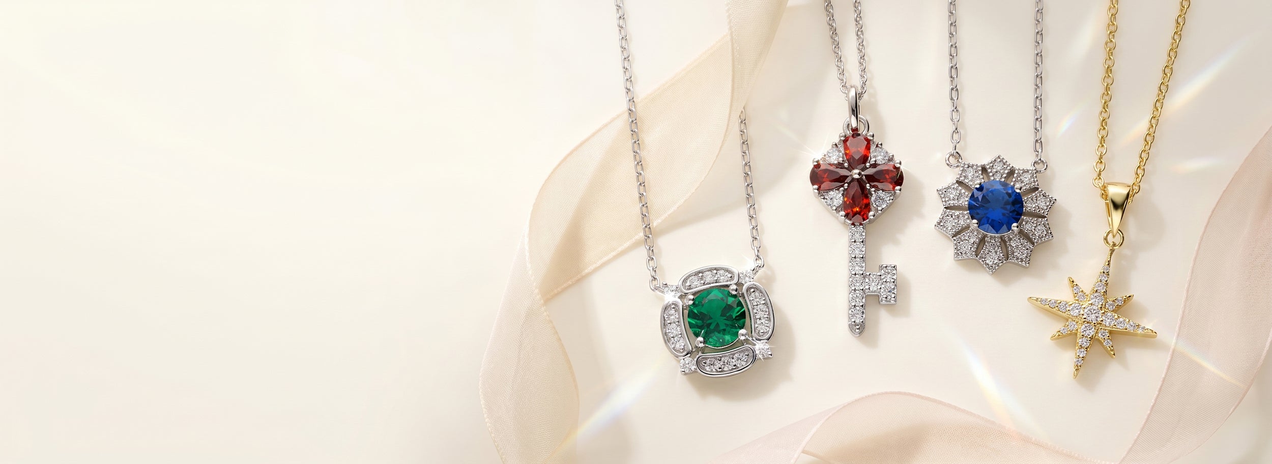 Four jewelry necklaces in colorstones on a white background