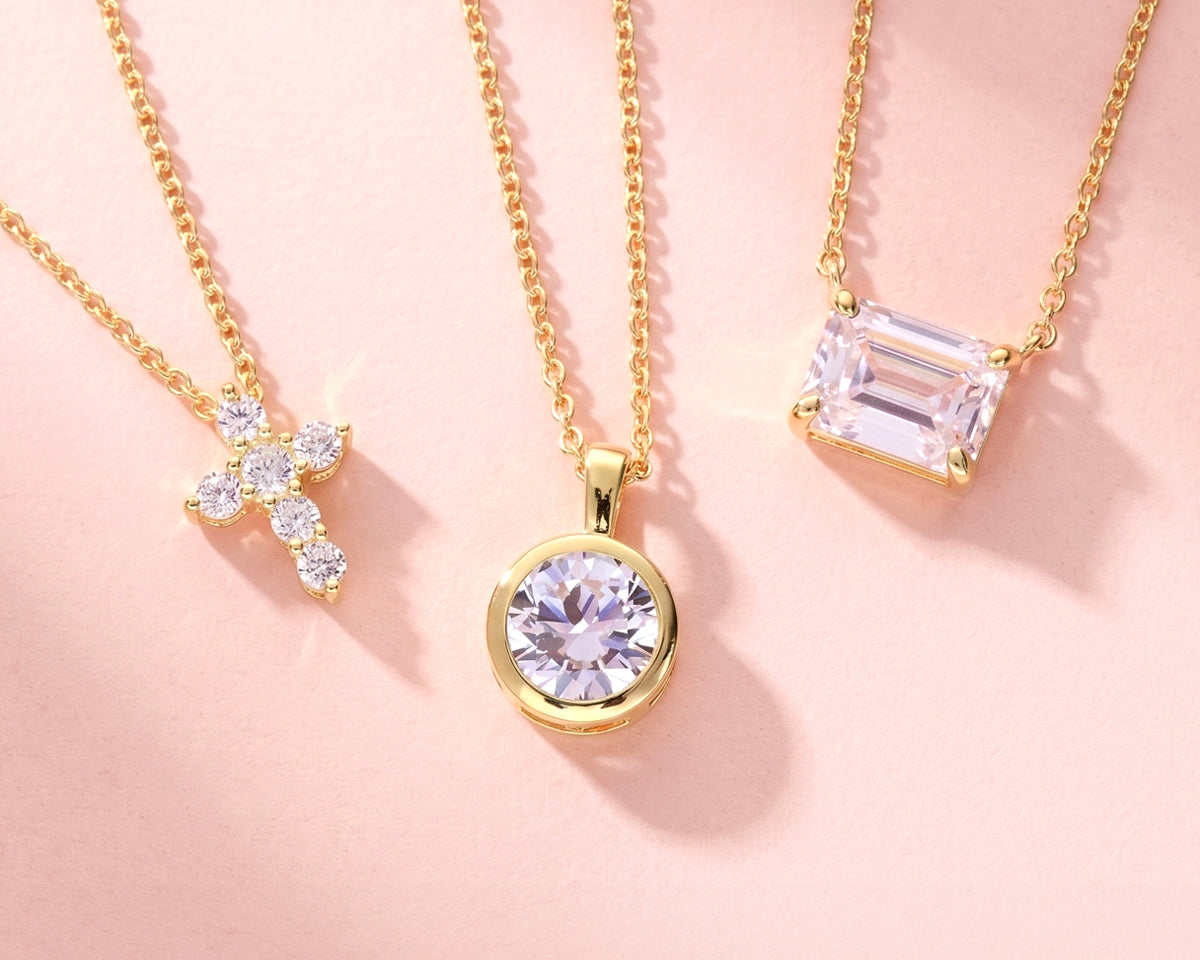 3 golden necklaces on a light color background