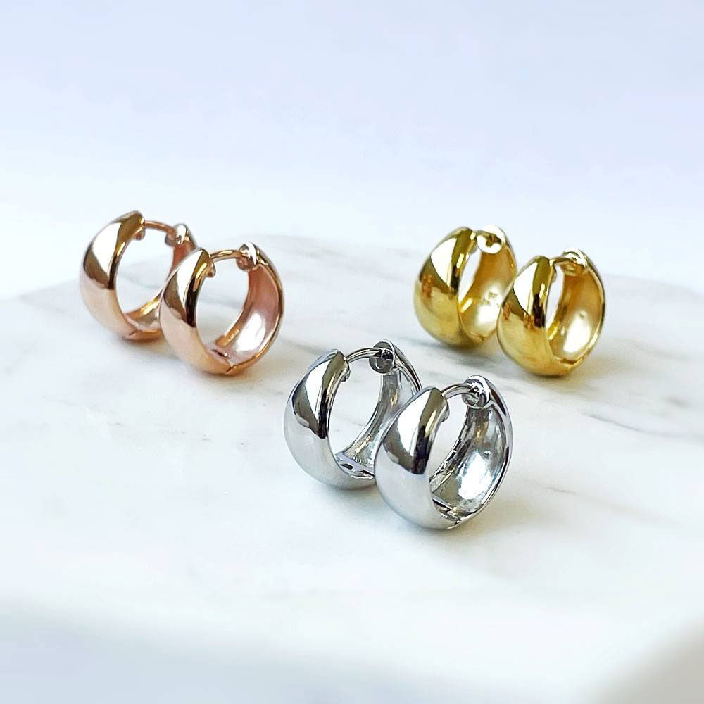 Flatlay view of Dome CZ Small Huggie Earrings in Sterling Silver 0.6 inch, Rhodium Plated